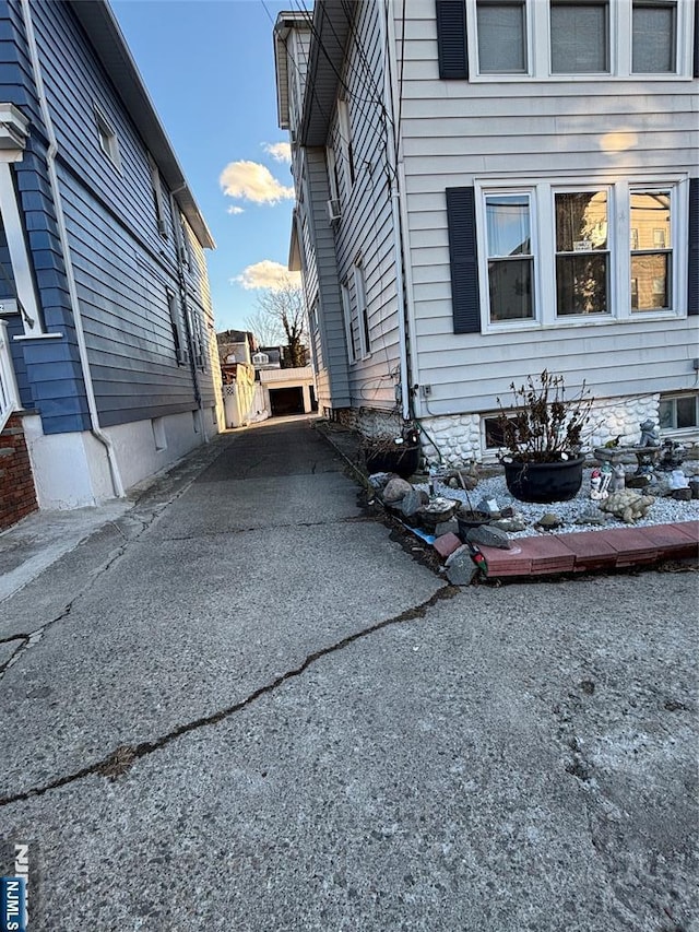 view of side of property featuring aphalt driveway