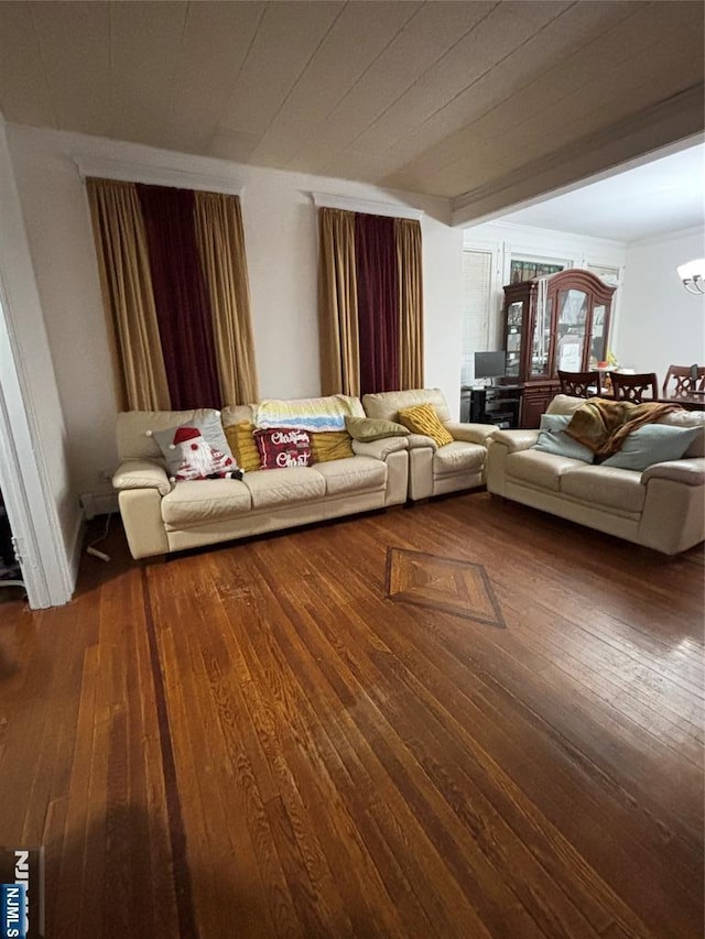 unfurnished living room featuring a chandelier and wood finished floors