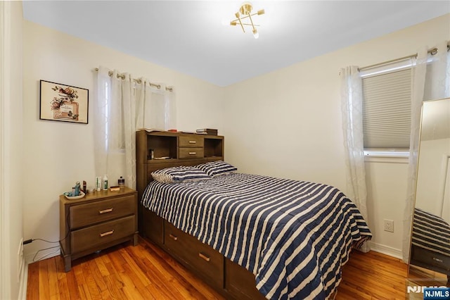 bedroom featuring wood finished floors and baseboards