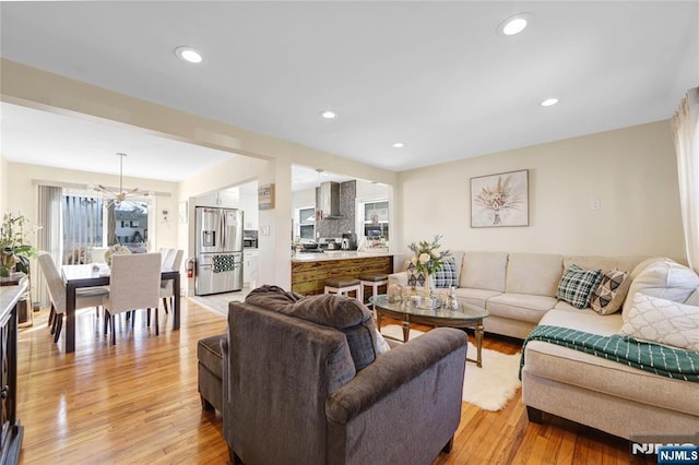 living room with light wood-style floors and recessed lighting