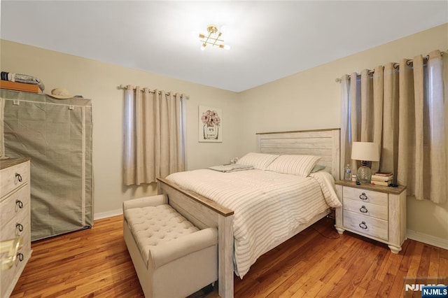 bedroom featuring wood finished floors and baseboards