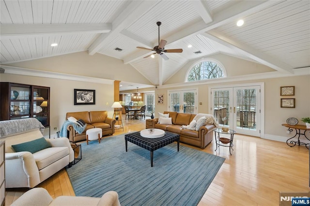 living area with ceiling fan, light wood-style flooring, baseboards, french doors, and beam ceiling