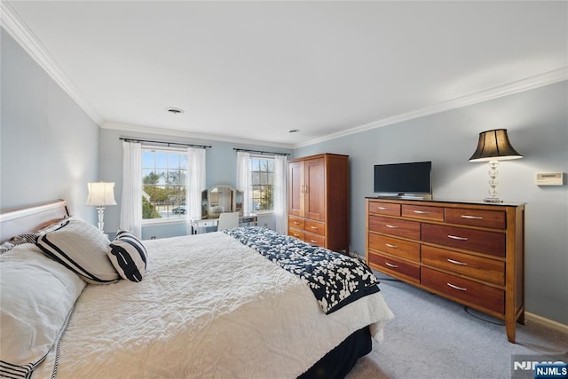 carpeted bedroom with visible vents, baseboards, and crown molding