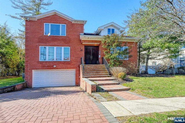 traditional-style home with a garage, decorative driveway, brick siding, and a front lawn