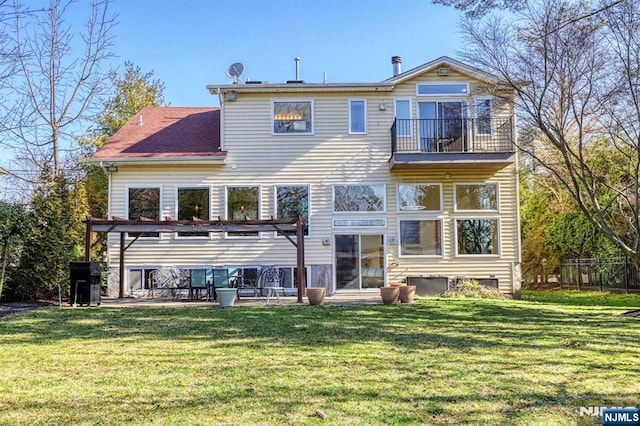 rear view of property with a yard, a patio area, fence, a balcony, and a pergola