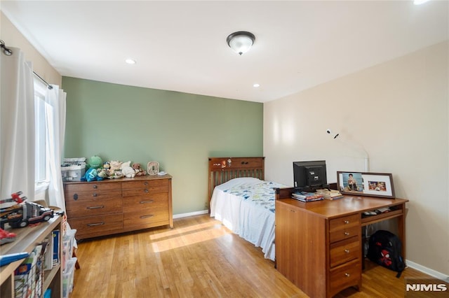 bedroom with light wood finished floors, recessed lighting, and baseboards