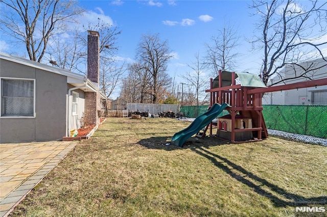 view of yard featuring a playground and a fenced backyard