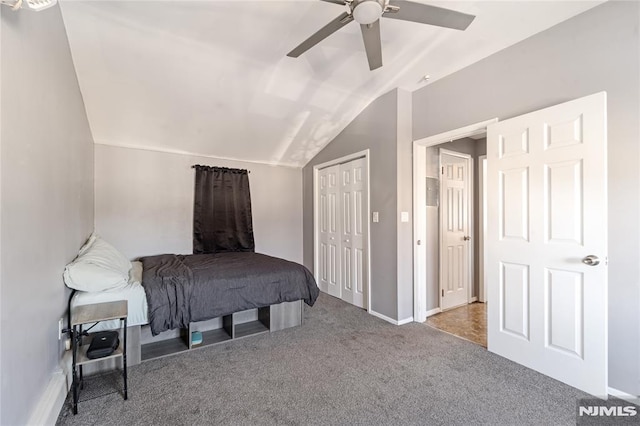 bedroom featuring lofted ceiling, light carpet, a ceiling fan, baseboards, and a closet