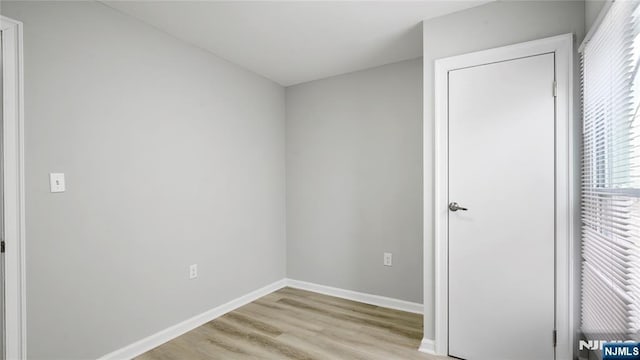 unfurnished bedroom with light wood-style floors and baseboards