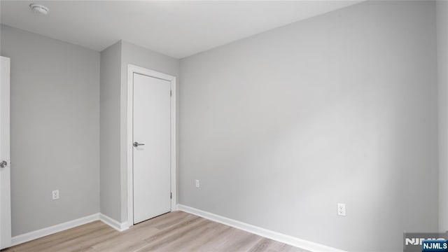 unfurnished bedroom featuring light wood-style floors and baseboards