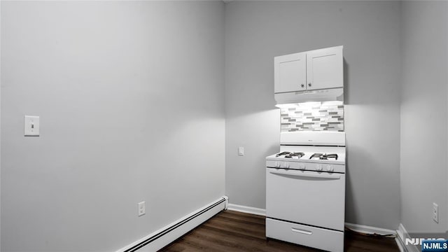 kitchen featuring under cabinet range hood, a baseboard heating unit, white cabinets, white gas range oven, and dark wood-style floors