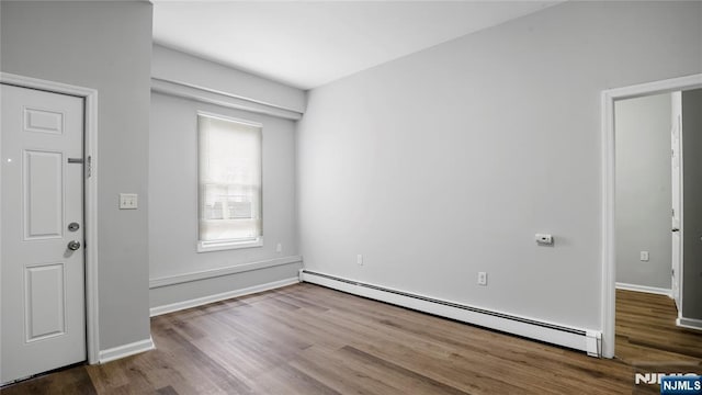 entryway with baseboards, baseboard heating, and wood finished floors