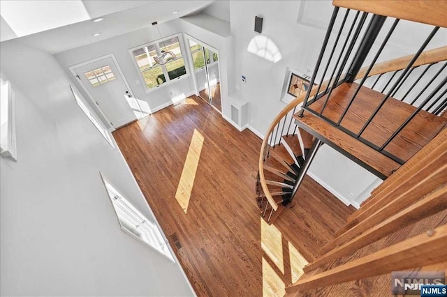 stairs featuring wood finished floors and baseboards