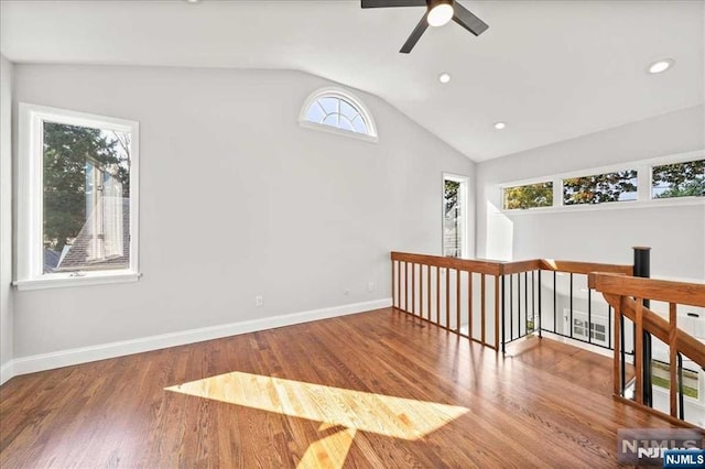 spare room featuring baseboards, a ceiling fan, lofted ceiling, wood finished floors, and recessed lighting