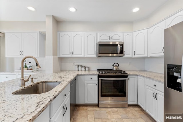 kitchen featuring white cabinetry, appliances with stainless steel finishes, and a sink