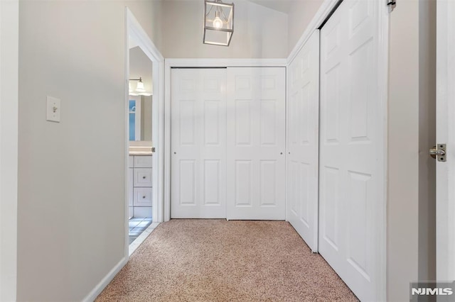 corridor with carpet and baseboards