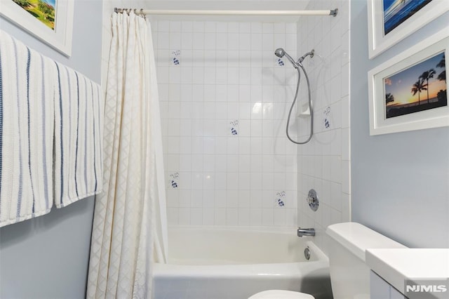 full bathroom with toilet, shower / tub combo with curtain, and vanity