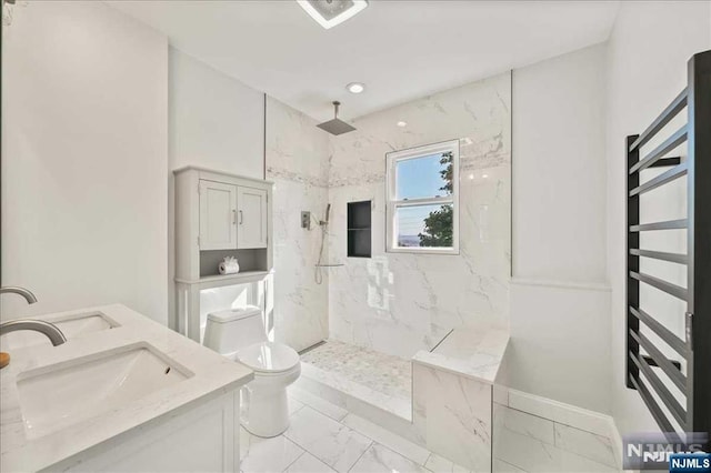 full bath featuring marble finish floor, a marble finish shower, a sink, and toilet