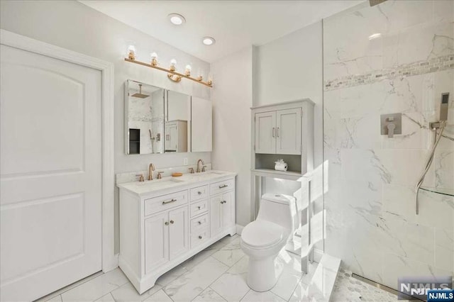 bathroom featuring marble finish floor, a sink, a marble finish shower, and double vanity