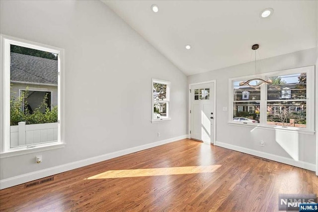 foyer entrance with lofted ceiling, recessed lighting, visible vents, wood finished floors, and baseboards