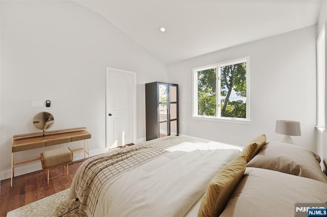 bedroom with recessed lighting, vaulted ceiling, baseboards, and wood finished floors