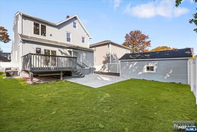 rear view of house with a wooden deck, fence, a yard, a patio area, and an outdoor structure