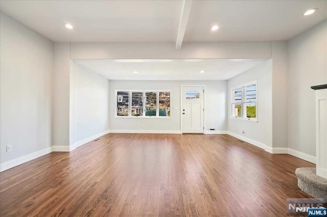 unfurnished living room with beam ceiling, baseboards, dark wood-style flooring, and recessed lighting