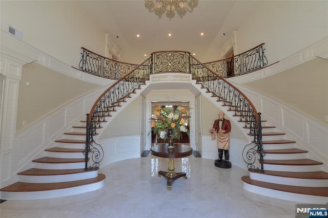 entrance foyer with stairway, recessed lighting, visible vents, and a decorative wall