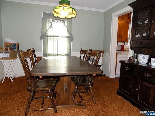 carpeted dining space with ornamental molding