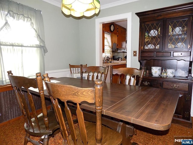 dining area with crown molding