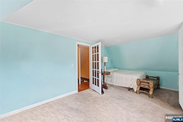 bedroom featuring vaulted ceiling, carpet flooring, and baseboards