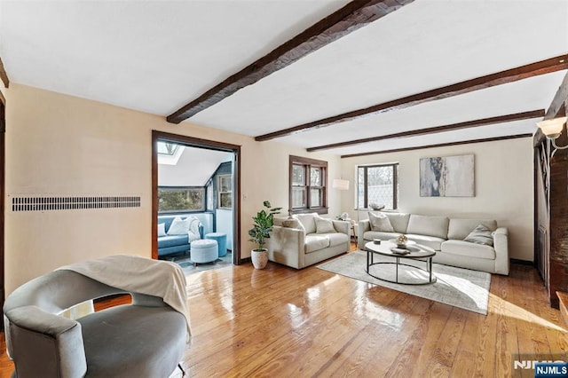 living room with beamed ceiling, wood finished floors, and baseboards