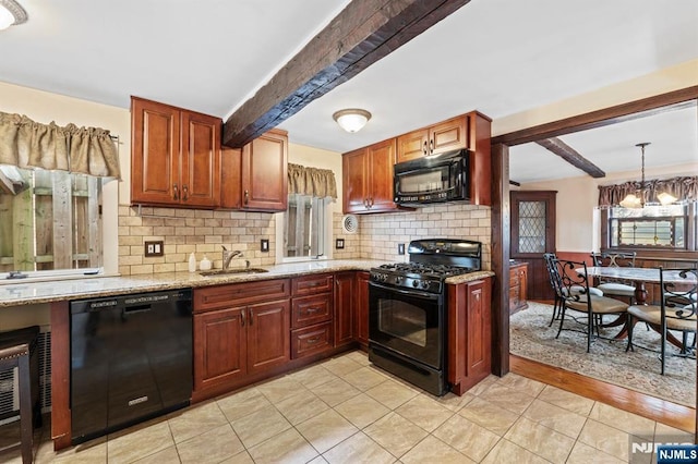 kitchen with light stone counters, a sink, beam ceiling, black appliances, and tasteful backsplash