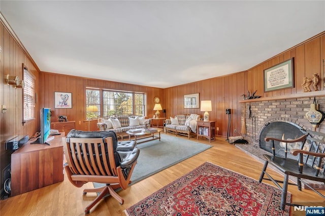 living room featuring a healthy amount of sunlight, light wood-style floors, and a fireplace