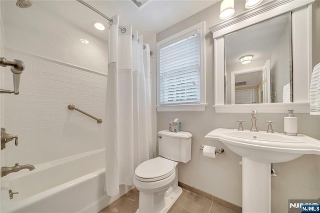 bathroom with visible vents, toilet, shower / tub combo, baseboards, and tile patterned floors