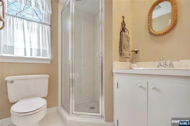 bathroom featuring toilet, a stall shower, and a wealth of natural light