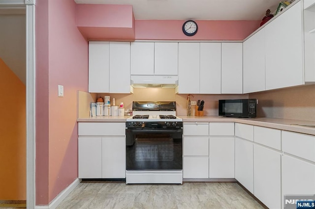 kitchen with black microwave, light countertops, under cabinet range hood, and gas range