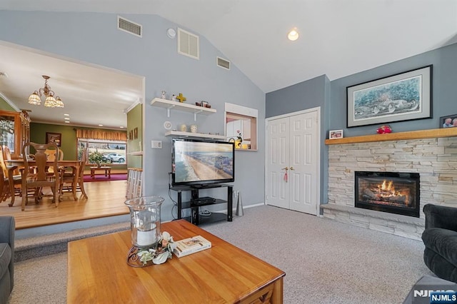 living room with a fireplace, carpet flooring, and visible vents