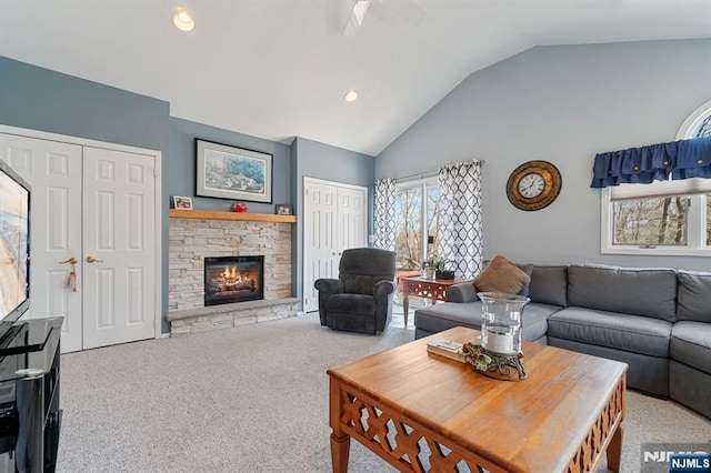 carpeted living area featuring high vaulted ceiling, a fireplace, and recessed lighting