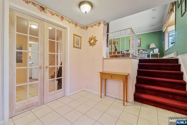 interior space with tile patterned floors, baseboards, stairway, and french doors