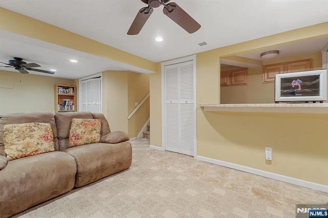 carpeted living area featuring stairs, recessed lighting, visible vents, and baseboards