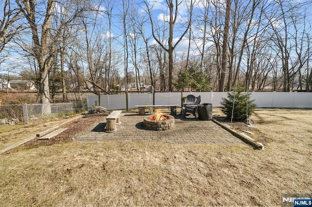 view of yard featuring an outdoor fire pit and a fenced backyard