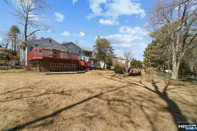 view of yard featuring a deck and fence