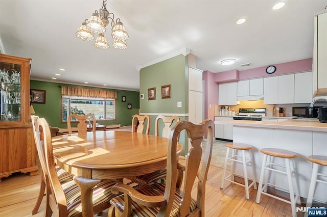 dining area featuring ornamental molding, recessed lighting, visible vents, and light wood-style floors