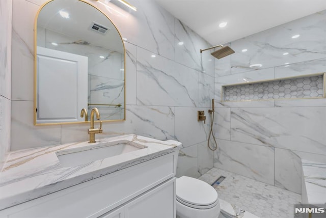 full bathroom featuring a marble finish shower, visible vents, toilet, vanity, and recessed lighting