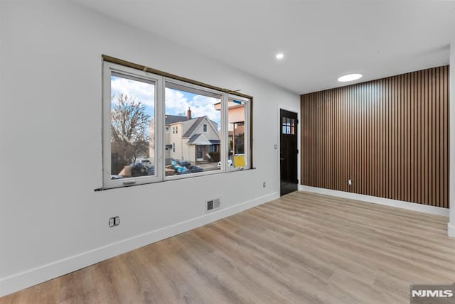 spare room featuring baseboards, visible vents, wood finished floors, and recessed lighting