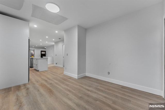 unfurnished living room featuring baseboards, light wood-type flooring, and recessed lighting