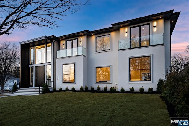 view of front of property with a yard and stucco siding