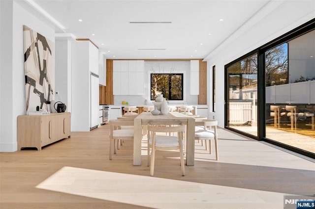 dining area with recessed lighting and light wood-style floors