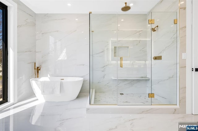 bathroom featuring a freestanding tub, a marble finish shower, and marble finish floor